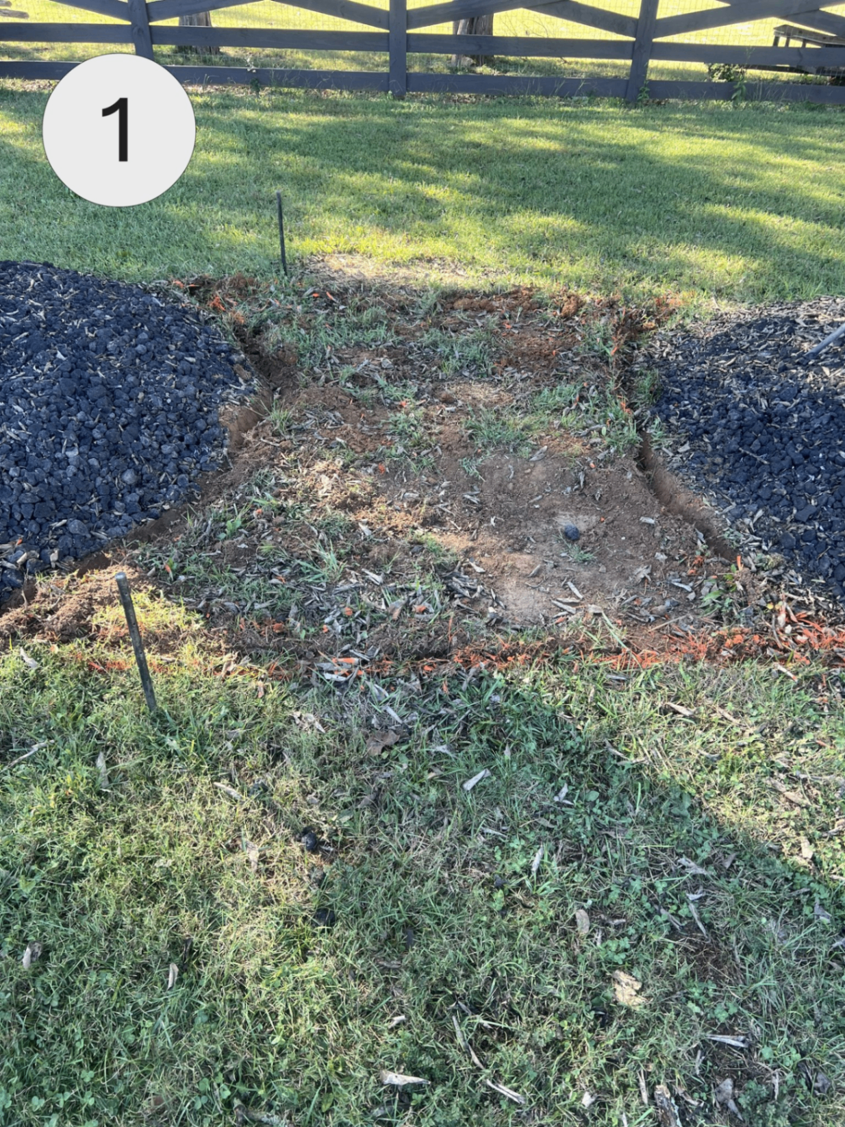 Excavation and prep work for a new stone walkway between mulch beds