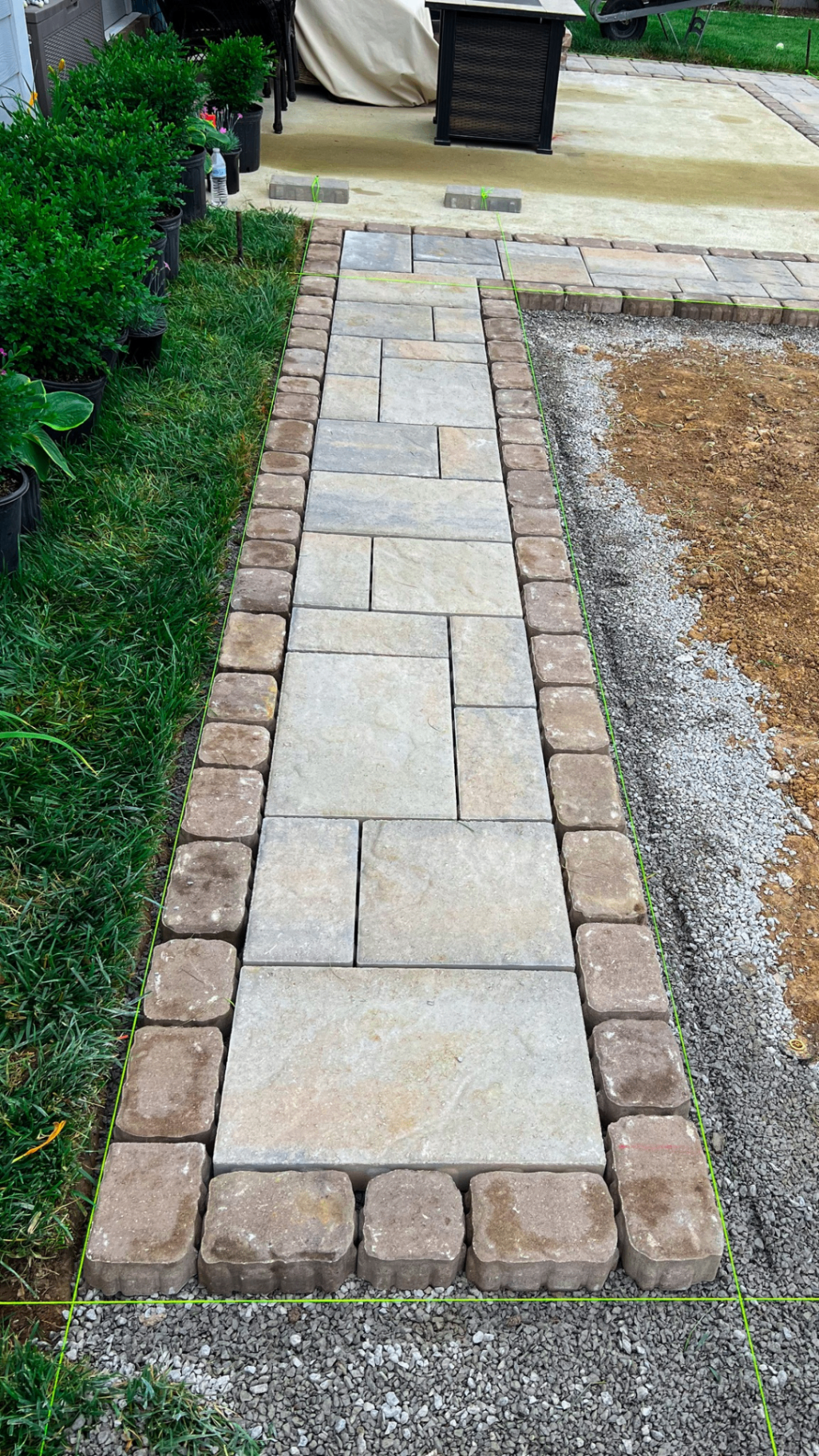 Finished paver and flagstone walkway leading to backyard patio