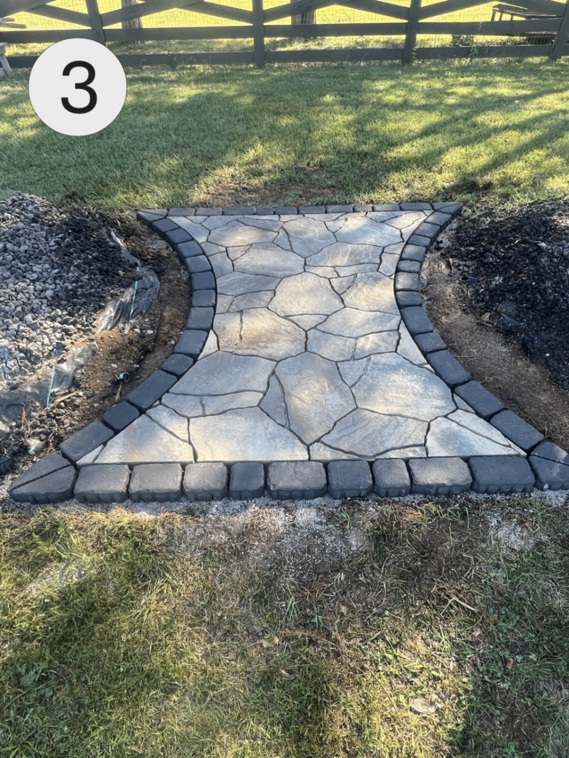 Finished flagstone walkway with charcoal cobblestone border